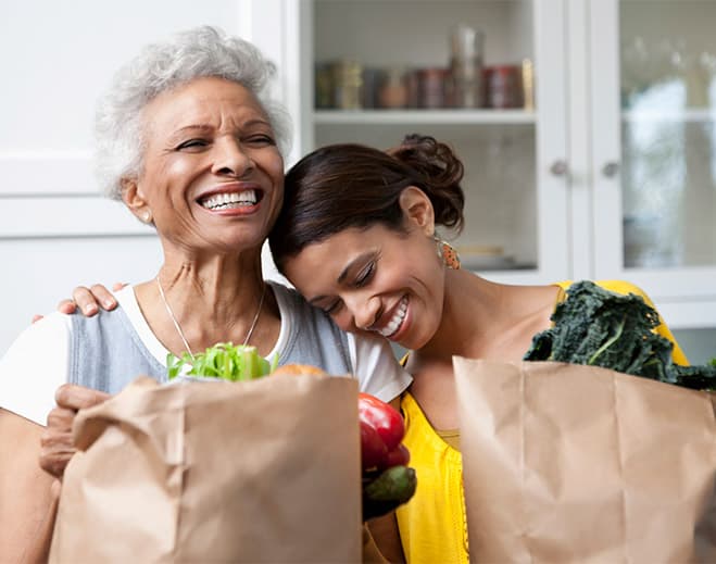 Mom and Daughter holding groceries