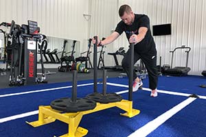 man pushing weight sled