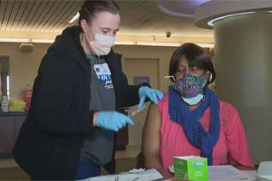 Beverly Cravin receiving her first COVID-19 vaccine